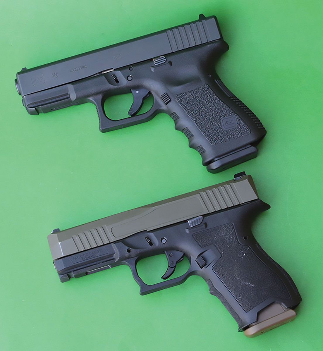 The Glock 19 (top) is probably the world’s most popular 9mm pistol. The PSA Dagger Compact is patterned after the Glock and even utilizes 100 percent magazine interchangeability.